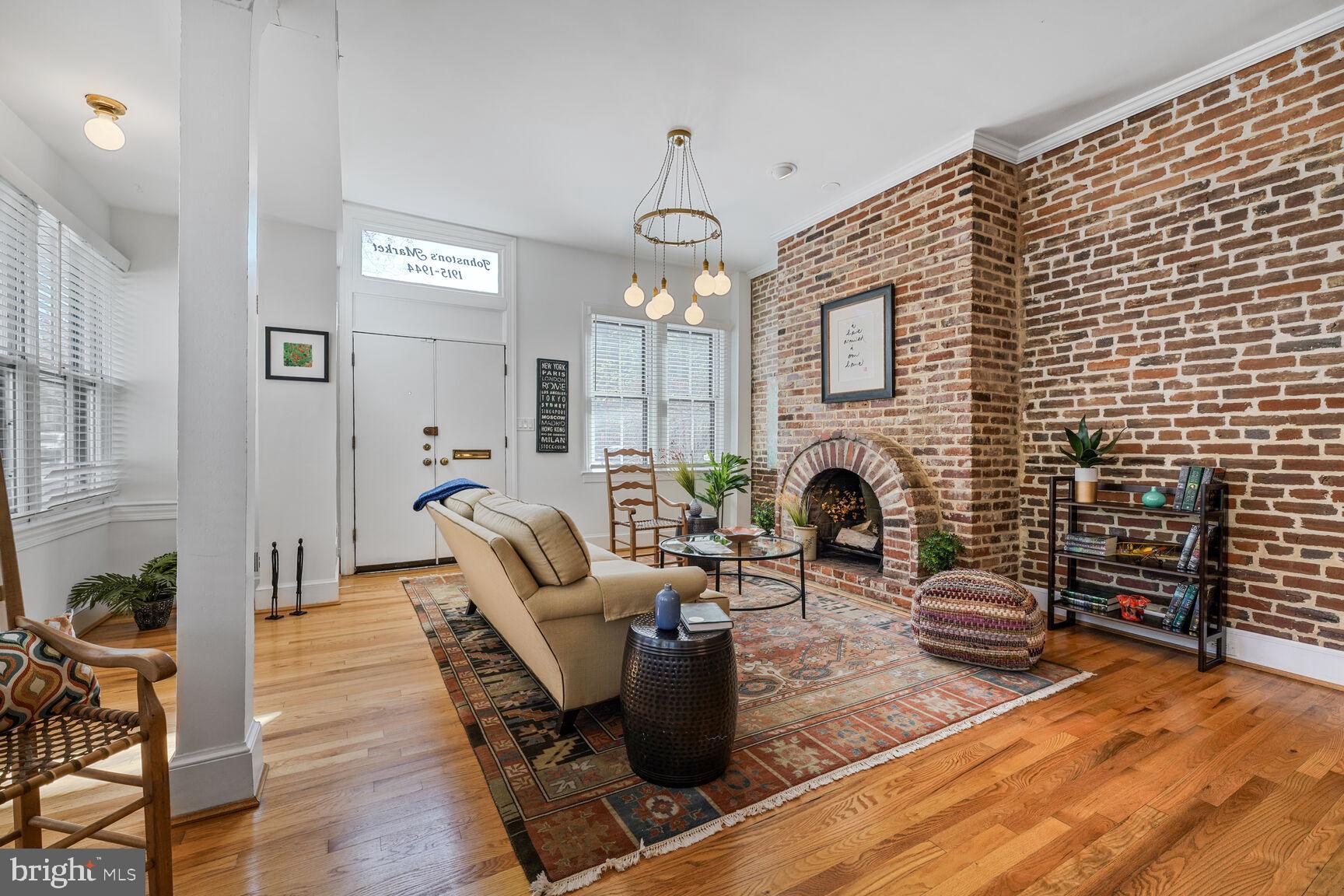 252 10th Street Northeast Washington, DC 20002 - Photo 5 of 31 a living room with furniture a fireplace and a chandelier