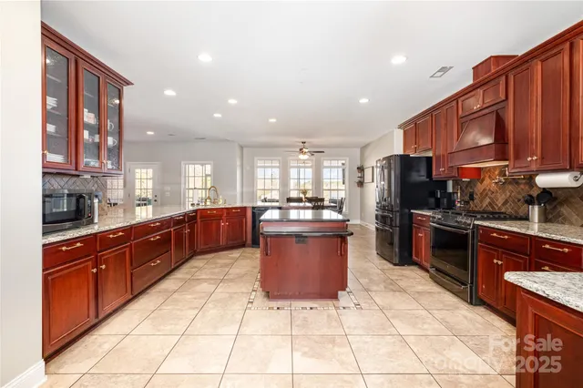 a large kitchen with stainless steel appliances lots of counter top space