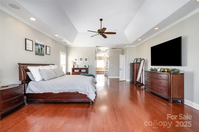 a bedroom with furniture and a flat screen tv