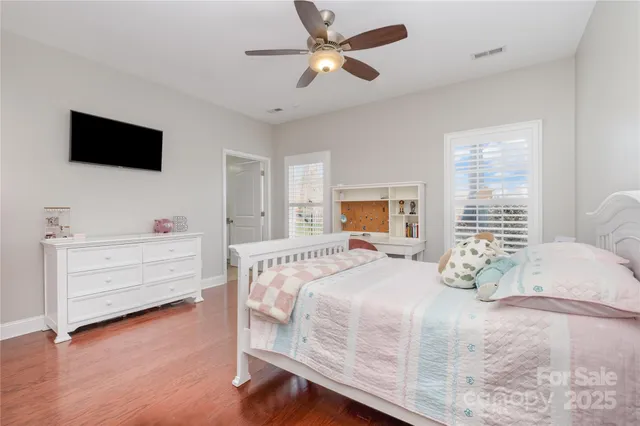 a bed room with a bed and a flat screen tv