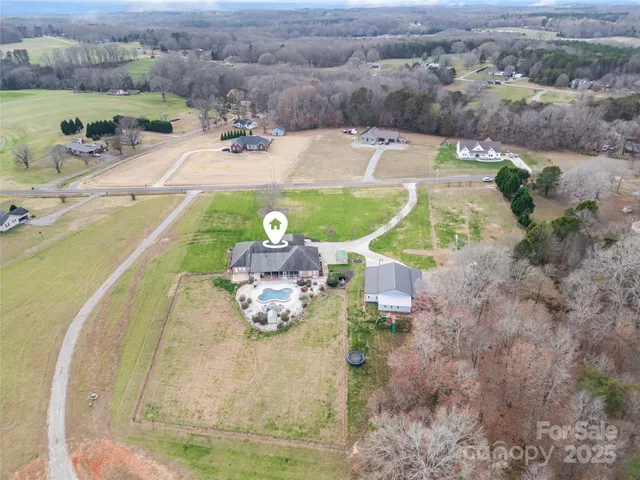 an aerial view of a house with outdoor space
