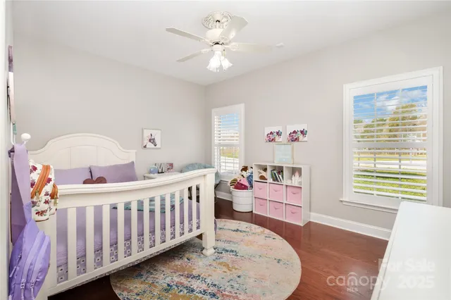a bedroom with furniture and a wooden floor