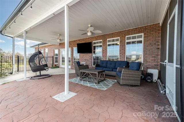 a view of a patio with table and chairs
