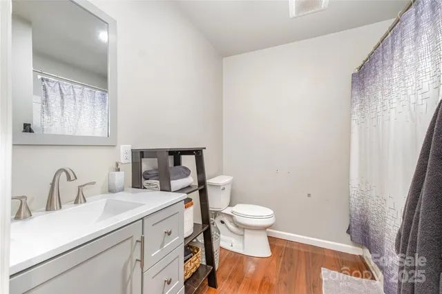 a bedroom with a bed and a lamp with the dresser