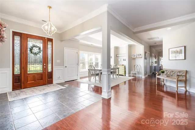 a view of a livingroom with furniture wooden floor and windows