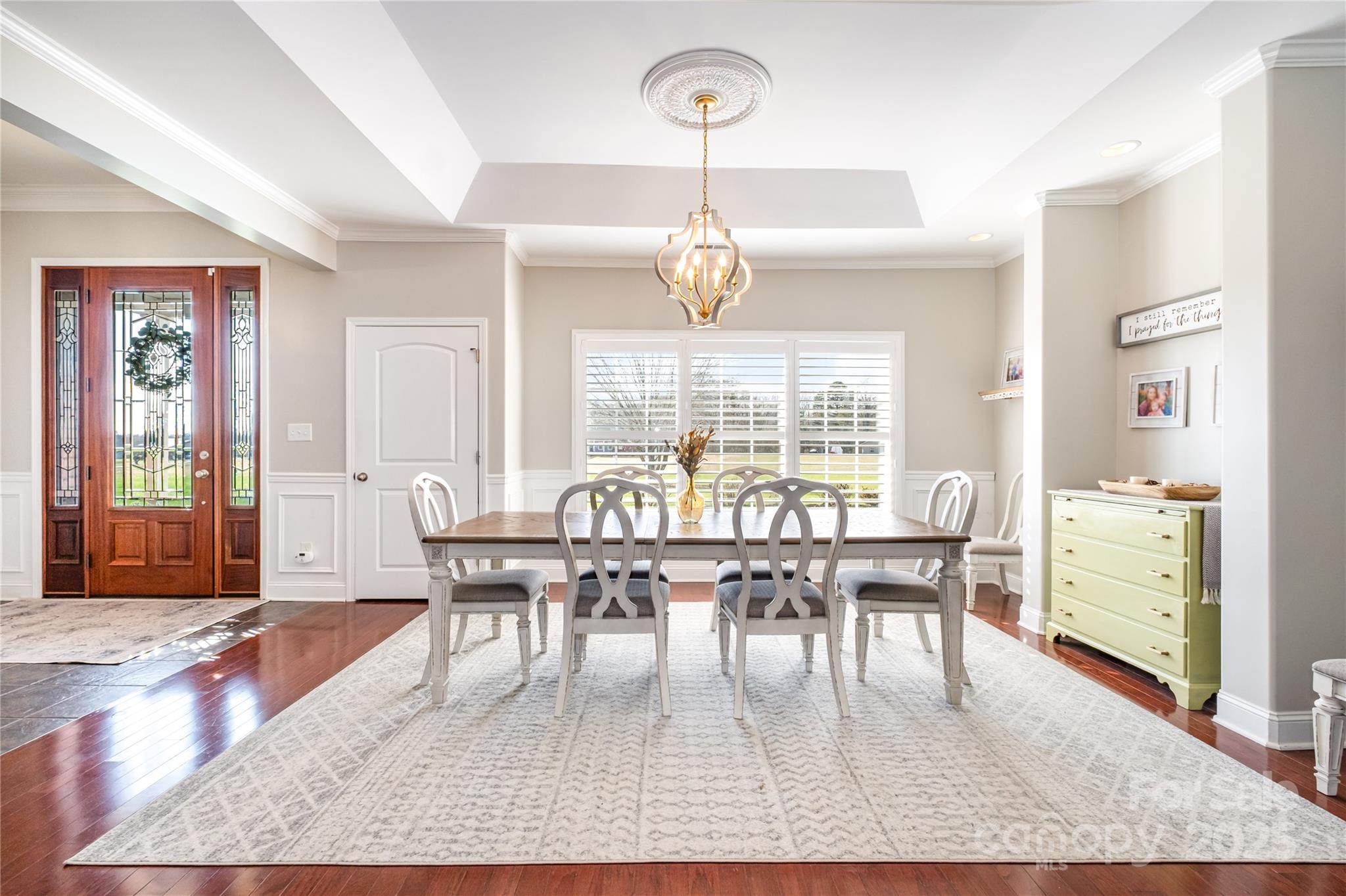 167 Black Road Statesville, NC 28677 - Photo 7 of 48 a dining room with wooden floor a chandelier a wooden table and chairs