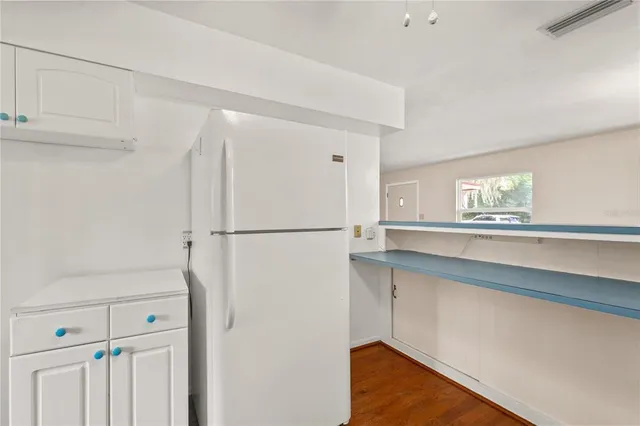 a kitchen with a refrigerator and a window