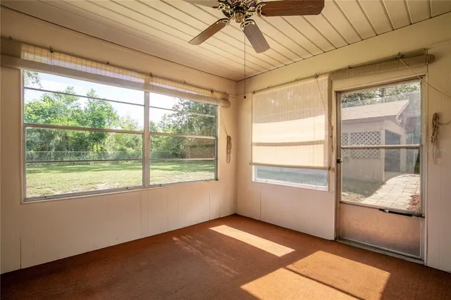 a view of an empty room and a window