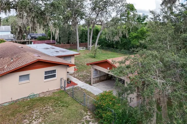 a backyard of a house with table and chairs