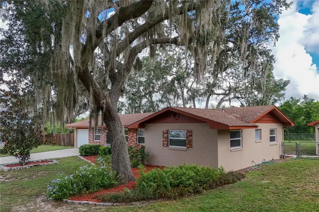 a front view of house with yard and trees