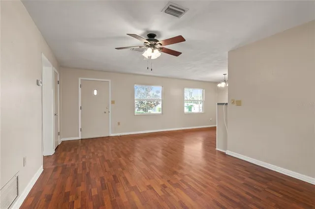 wooden floor in an empty room with a window