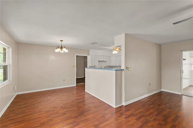 a view of a kitchen with wooden floor and window