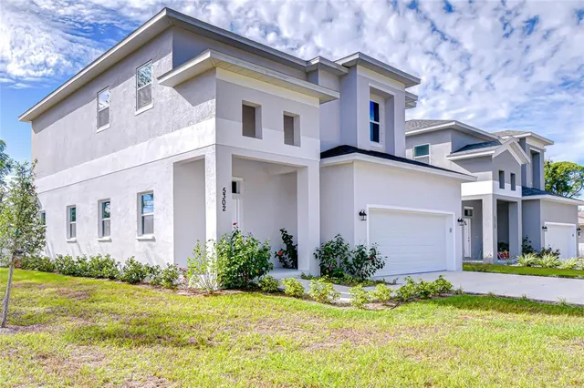 a front view of house with yard and green space