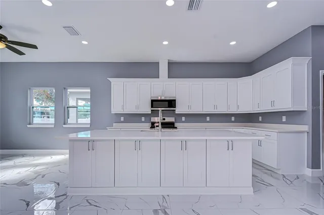 a kitchen with white cabinets