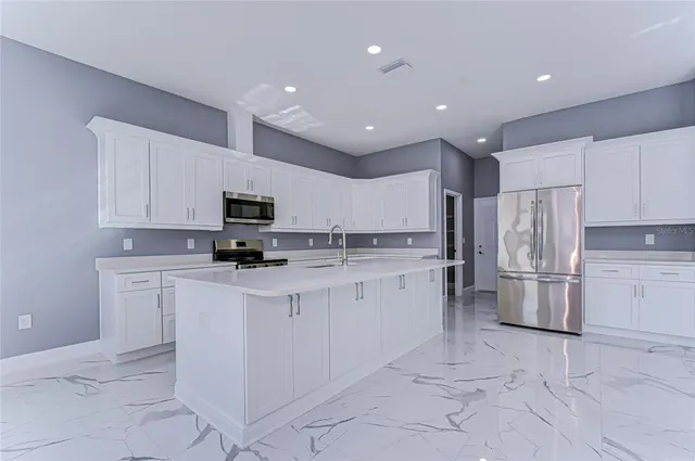 a kitchen with a refrigerator and microwave