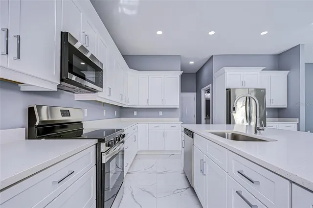 a kitchen with a sink stainless steel appliances and cabinets