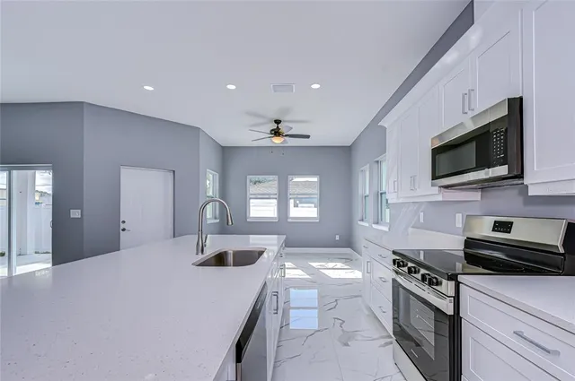 a kitchen with a sink stainless steel appliances and cabinets