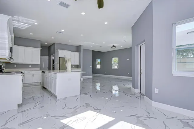 a large bathroom with a large mirror vanity and shower