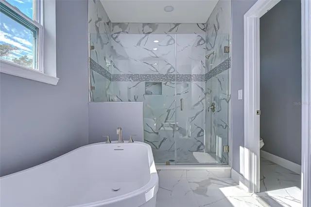 a bathroom with a bathtub and shower