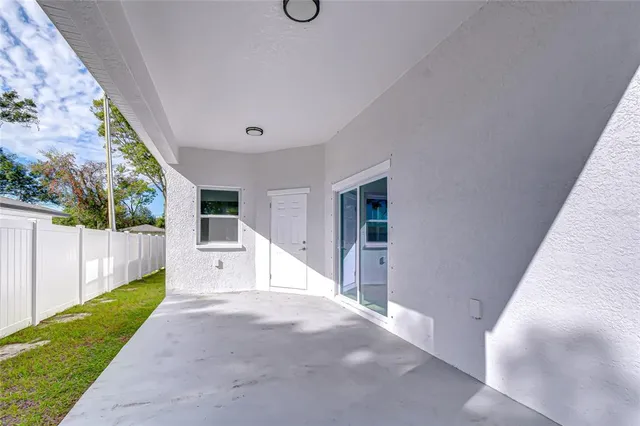 a view of a house with backyard and trees