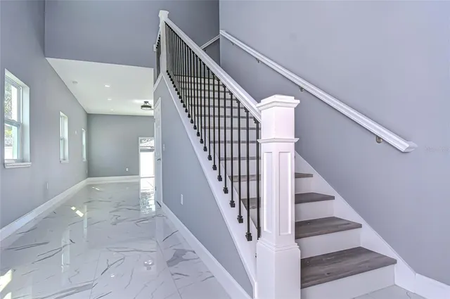 a view of entryway and hall with wooden floor