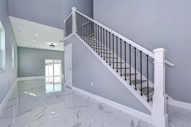 a view of entryway and hall with wooden floor
