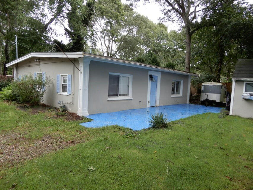 a view of backyard of house with outdoor seating and green space