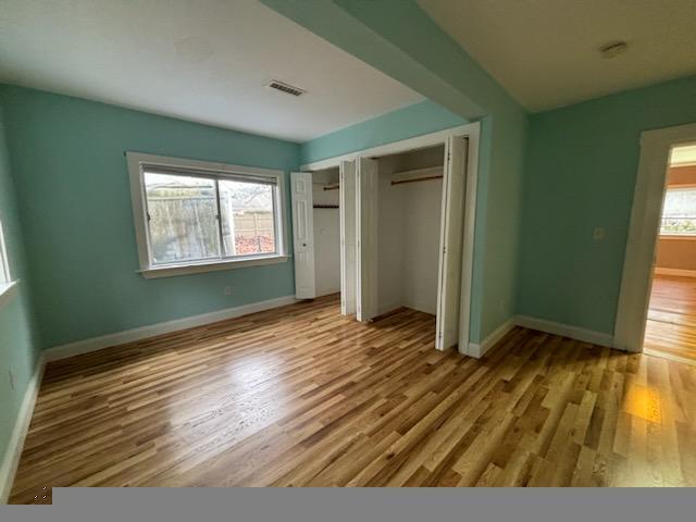 14 Bee Lane Centerville, MA 02632 - Photo 2 of 8 an empty room with wooden floor and windows
