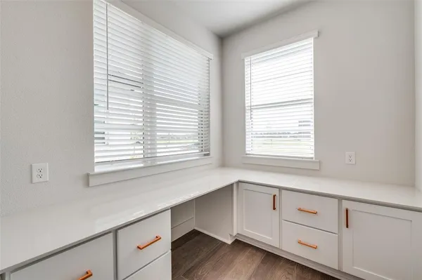a kitchen with granite countertop white cabinets and a window