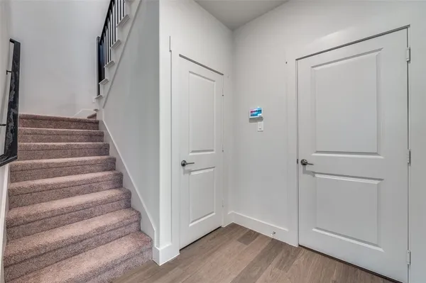 a view of an entryway with wooden floor