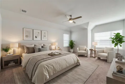 a spacious bedroom with a bed a couch and potted plant