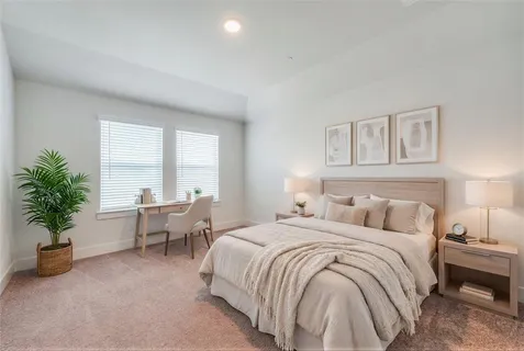 a bedroom with a bed and a potted plant