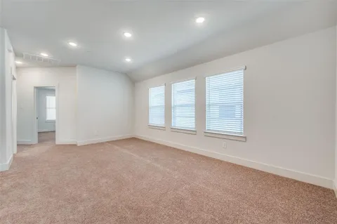 an empty room with windows and closet