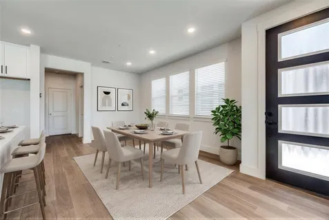 a view of a dining room with furniture and window