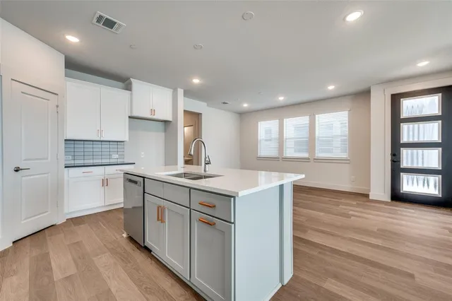 a kitchen with a sink stove and cabinets