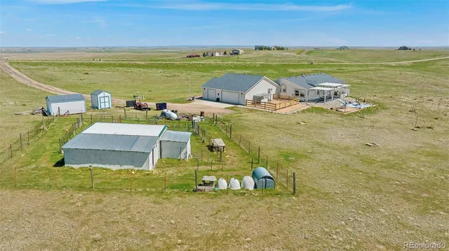 a front view of a house with swimming pool yard and outdoor seating