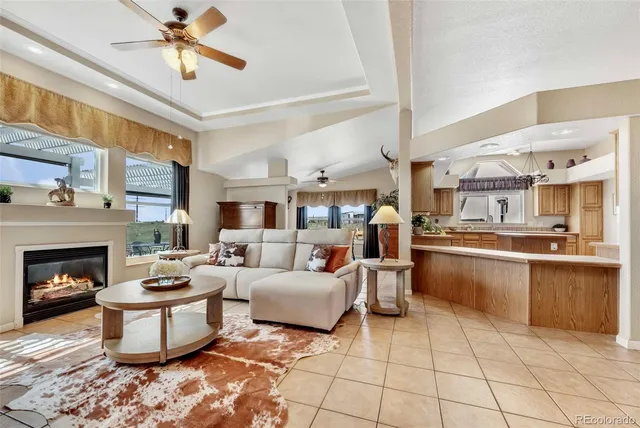 a room with stainless steel appliances kitchen island granite countertop furniture and a window