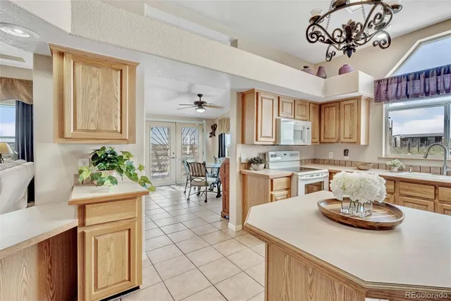 a living room with furniture a table and a large window