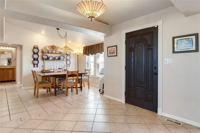 a view of workspace with lounge chair and windows