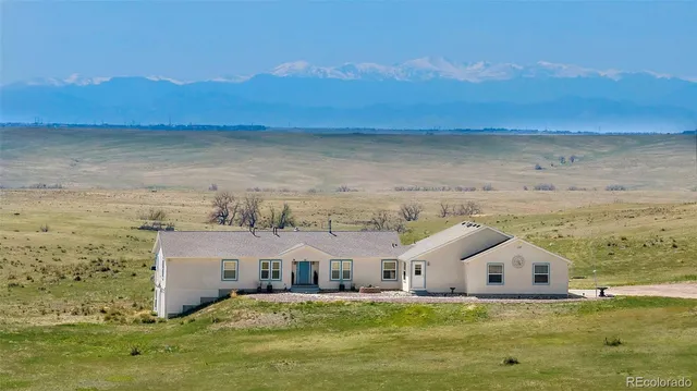 a view of a big house with a big yard