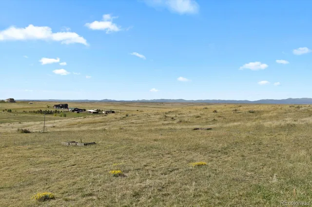 a view of a balcony with table and chairs couches with wooden floor