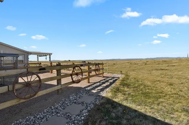 a view of a porch with a table and chairs