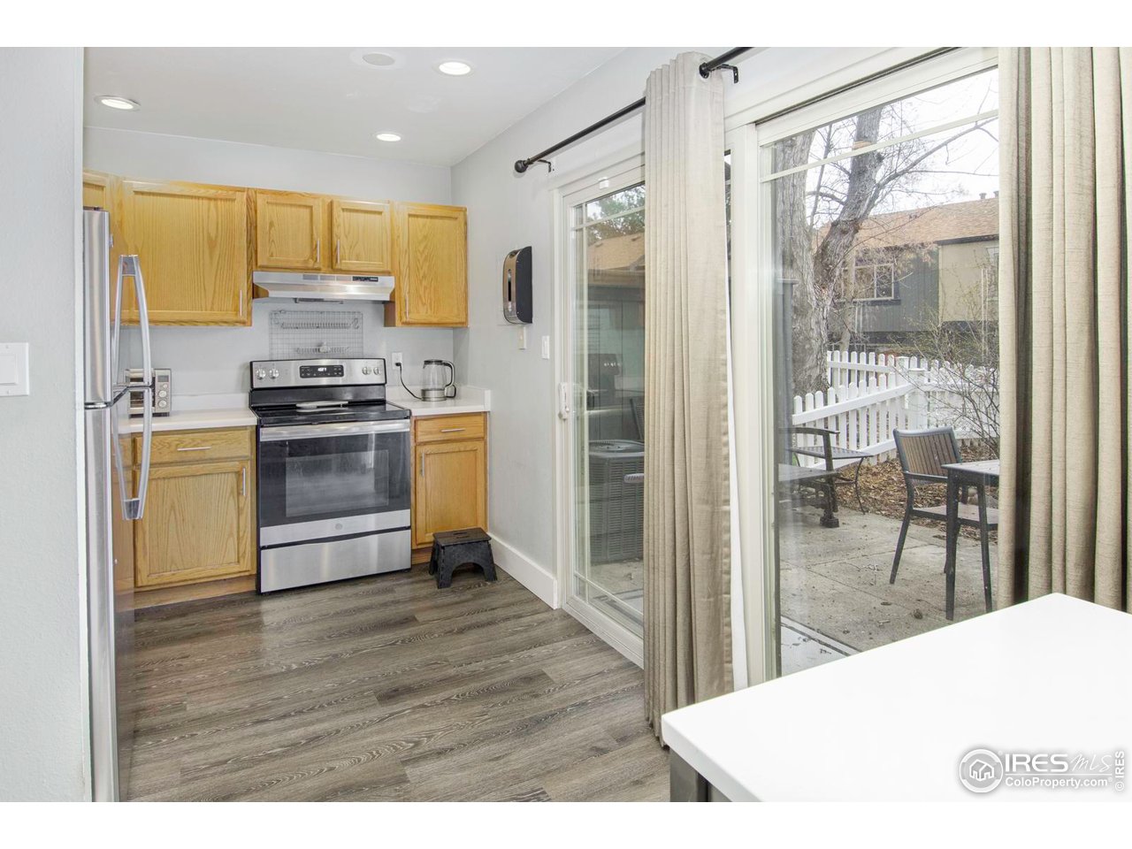 750 West Moorhead Circle, Unit A Boulder, CO 80305 - Photo 6 of 35 a kitchen with stainless steel appliances a stove a refrigerator a sink a oven with wooden floor