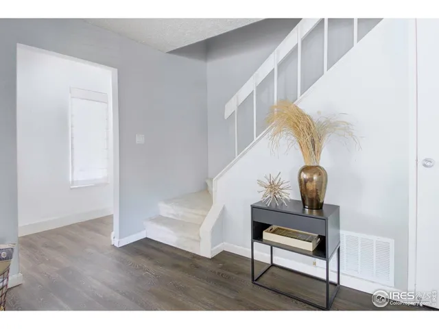 a view of entryway and hall with wooden floor