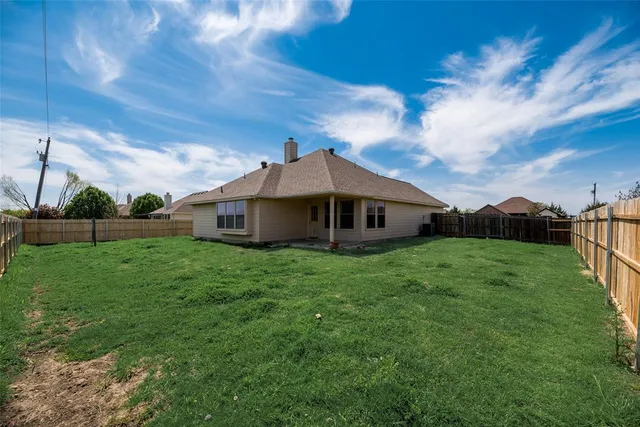 a aerial view of a house next to a yard