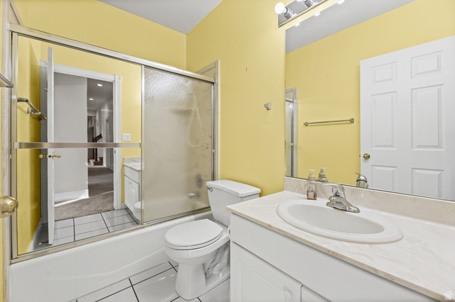 4117 North Wolf Ridge Circle Eden, UT 84310 - Photo 34 of 63 Bathroom featuring a white vanity with a built-in sink, an extended countertop, and a large mirror with overhead lighting