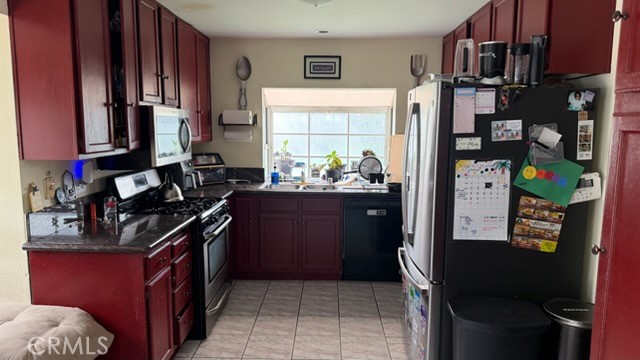 2478 KOA Drive Rialto, CA 92377 - Photo 2 of 18 a kitchen with stainless steel appliances granite countertop a refrigerator stove and a sink