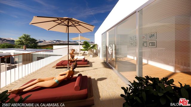 a sitting area with furniture and umbrella