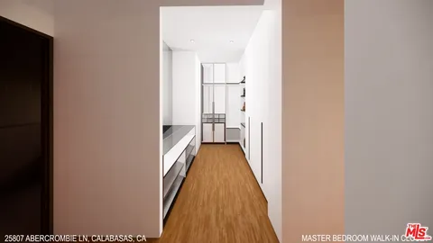 a view of a hallway with wooden floor and a bathroom