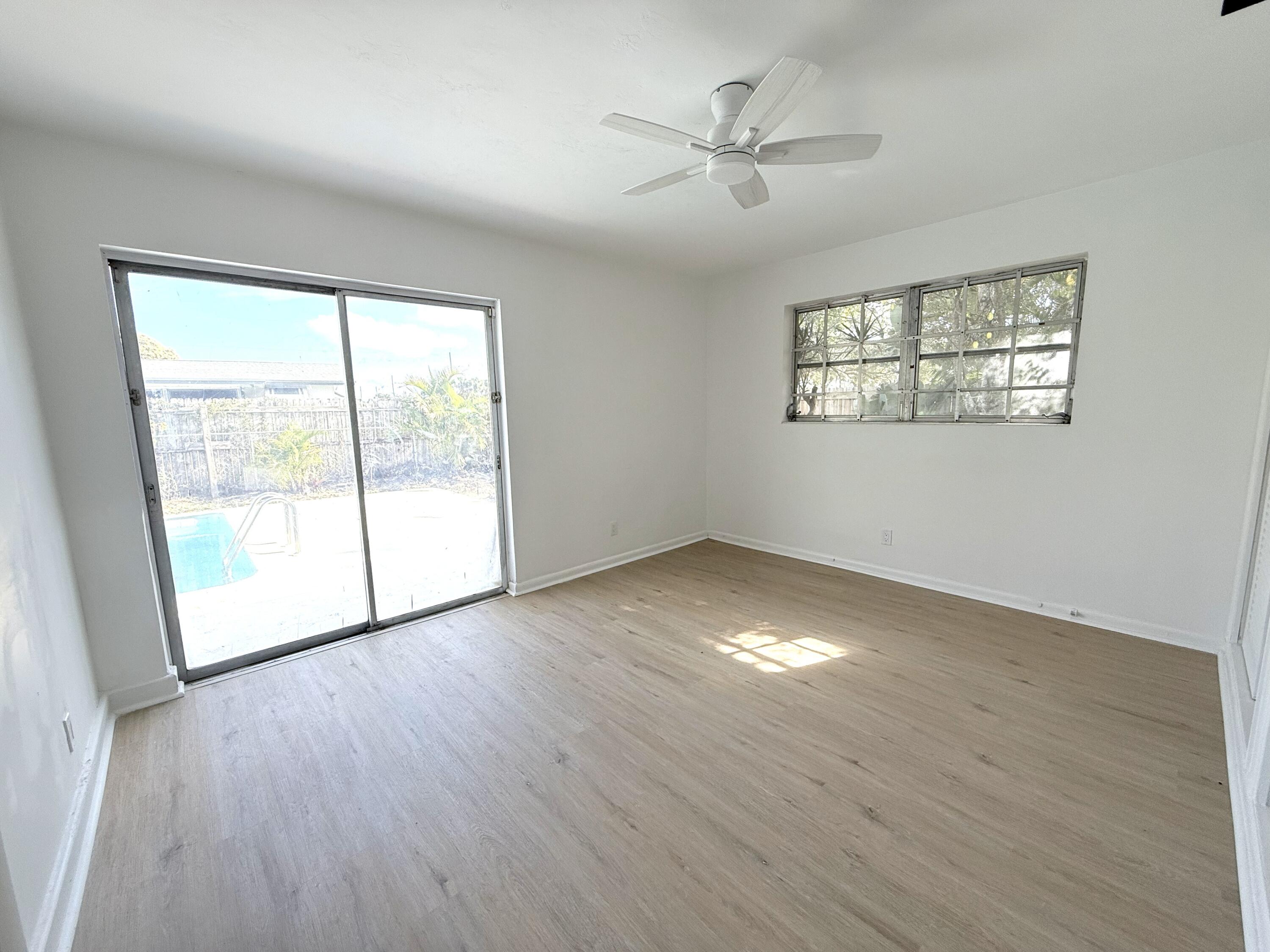 210 West 23rd Street Riviera Beach, FL 33404 - Photo 11 of 20 a view of an empty room with wooden floor and a window